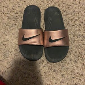 Gold Nike slides